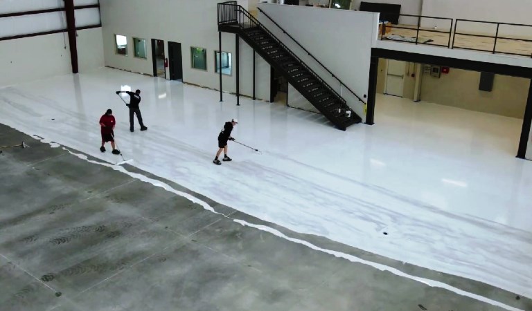 proses aplikasi cat epoxy lantai di hanggar pesawat terbang